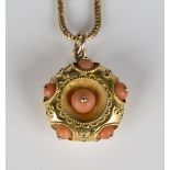 A gold and coral circular pendant locket with applied wirework decoration, as converted from a