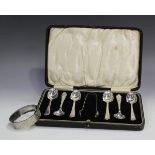 A set of six George V silver teaspoons and a pair of matching sugar tongs with floral decoration,