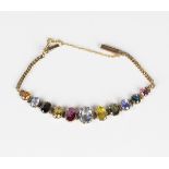 A gold and vari-coloured gemstone bracelet, claw set with a row of eleven graduated oval cut