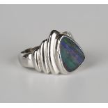 A platinum, opal and diamond ring, mounted with a curved triangular shaped opal and a row of four