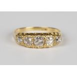 A gold and diamond five stone ring, mounted with a row of graduated cushion cut diamonds, the