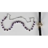 An amethyst necklace, claw set with a row of graduated circular cut amethysts, on a bar link chain
