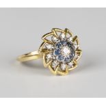 A gold, diamond and sapphire cluster ring in a pierced design, mounted with the principal circular