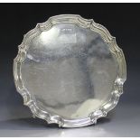 A George VI silver salver with piecrust rim, on scroll feet, Sheffield 1944 by Roberts & Dore,