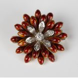 A gold, diamond and red enamelled brooch, designed as a flowerhead, mounted with seven circular