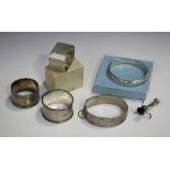 Two silver napkin rings, both with engine turned decoration, London 1934 and Birmingham 1955,