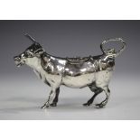 An early 20th century German silver cow creamer, modelled standing with tail curling to form the