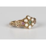 A Victorian gold, emerald, ruby and half-pearl set cluster ring with scroll pierced shoulders,