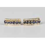 A pair of gold, sapphire and diamond earstuds, each mounted with a row of six circular cut sapphires