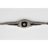 A diamond and black onyx bracelet, circa 1930, collet set with the principal cushion cut diamond