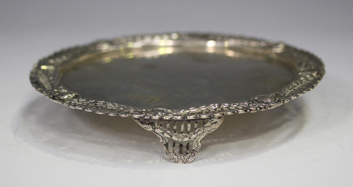 A late Victorian silver circular card salver, the cast rim pierced with portrait bust panels and - Image 3 of 4