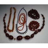A silver and lapis lazuli bead necklace, length 47cm, a graduated cornelian bead necklace, a coral