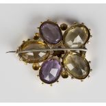 A Victorian gold, amethyst and citrine brooch, designed as a pansy flowerhead, mounted with five