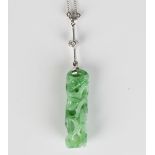 A jade and diamond pendant necklace, the jade drop carved and pierced with foliate motifs with a