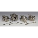 A pair of late Victorian silver oval mustards, each with gadrooned rim and wrythen fluted body,