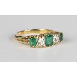 An Edwardian gold, emerald and diamond ring, circa 1910, mounted with three rectangular step cut