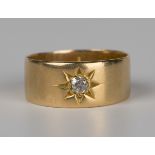 A gold and diamond single stone band ring, star gypsy set with a cushion cut diamond, detailed 'H.B.