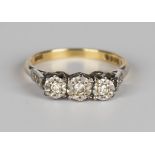 An 18ct gold ring, mounted with a row of three circular cut diamonds between diamond two stone