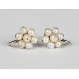 A pair of white gold and cultured pearl cluster earrings with screw fittings, detailed '9ct', with a