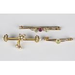 A gold and half-pearl bar brooch, the centre with a spray motif, detailed '15ct', width 4.5cm, a