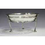 A George V silver pierced circular basket, raised on three ram's mask shouldered tapering legs