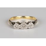 A gold and platinum ring, mounted with three circular cut diamonds in heart shaped settings,