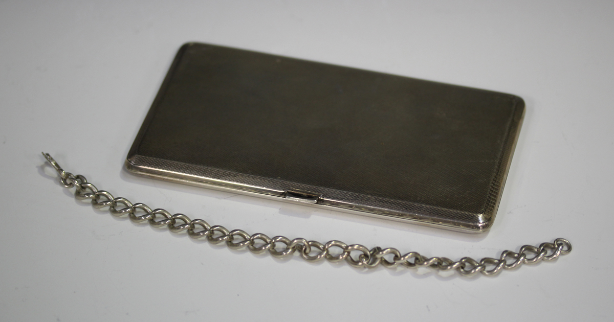 A George VI silver rectangular cigarette case with engine turned decoration, London 1947 by