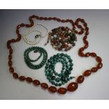 A reconstituted amber graduated oval faceted bead necklace, length 112cm, two malachite bead