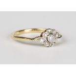A gold, platinum and diamond cluster ring in a floral and foliate design, mounted with seven cushion