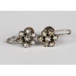 A pair of rose cut diamond set seven stone cluster earrings, the screw fittings detailed 'SS',
