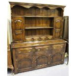 A 20th century Jacobean style oak dresser, the shelf back above drawers and cupboards, on stile