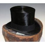 A black moleskin top hat by Henry Heath Ltd, head circumference 55cm, together with a brown