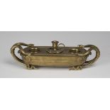 A mid-19th century gilt bronze inkstand, finely cast in the form of a boat with serpent handles, the