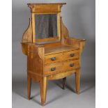 An Edwardian Arts and Crafts oak dressing chest, fitted with a swing mirror and two drawers,