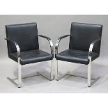 A pair of modern chromium plated metal and black leather cantilever armchairs, height 83cm, width