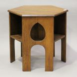 An early 20th century Arts and Crafts oak hexagonal book table, three sides pierced with teardrop