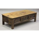 A 20th century French oak coffee table with hinged top, on block legs, height 42cm, width 140cm,