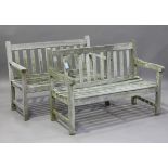 Two 20th century wooden slatted garden benches, widths 122cm (weathered and faults).Buyer’s