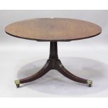 A George III mahogany circular tip-top breakfast table, the three reeded legs with brass caps and