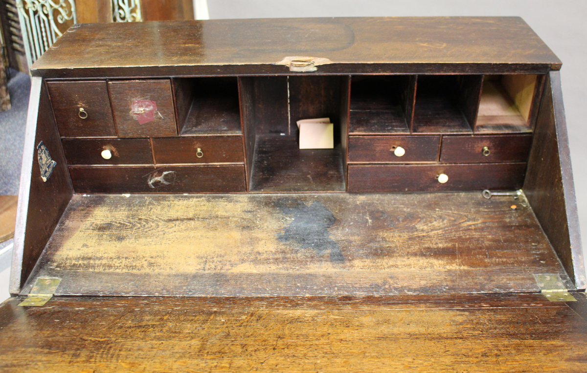 A George III oak bureau, the fall-flap above two short and three long drawers, on bracket feet, - Image 3 of 3