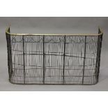 A 19th century wirework nursery fireguard, the top with brass trim, height 60cm, width 105cm.Buyer’s