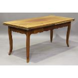 A 19th century French cherry draw-leaf farmhouse table, with a shaped apron and cabriole legs,