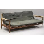 A mid-20th century Danish hardwood folding day bed, in the manner of Finn Juhl, the shaped arm