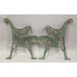 A pair of early 20th century green painted cast iron garden bench ends, height 72cm, depth 61cm.