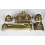 A late Victorian cast brass inkstand, decorated with cherubs and foliage, width 25cm, together