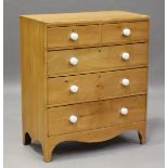 A late George III pine chest of drawers with applied white ceramic handles, on bracket feet,