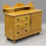 A Victorian pine dresser base, the gallery back above drawers and a cupboard, height 107cm, width