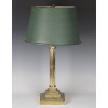 A 20th century brass Corinthian column table lamp base with a tole painted metal shade, height