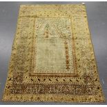 A Turkish silk prayer rug fragment, late 19th/early 20th century, the ivory mihrab with arch and