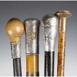 A group of four walking canes, including a 19th century Malacca walking cane with Burmese engraved